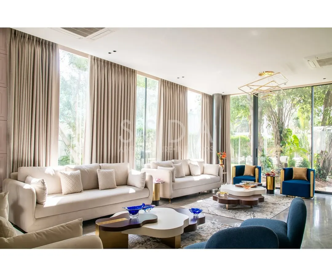 Our design for House Retold reimagined an older home by opening it up to its quaint garden. We used expansive glazed doors to dissolve the boundary between the living room and the outdoors, transforming the space into a place of quiet connection with nature. This seamless flow invites light and greenery deep into the home.