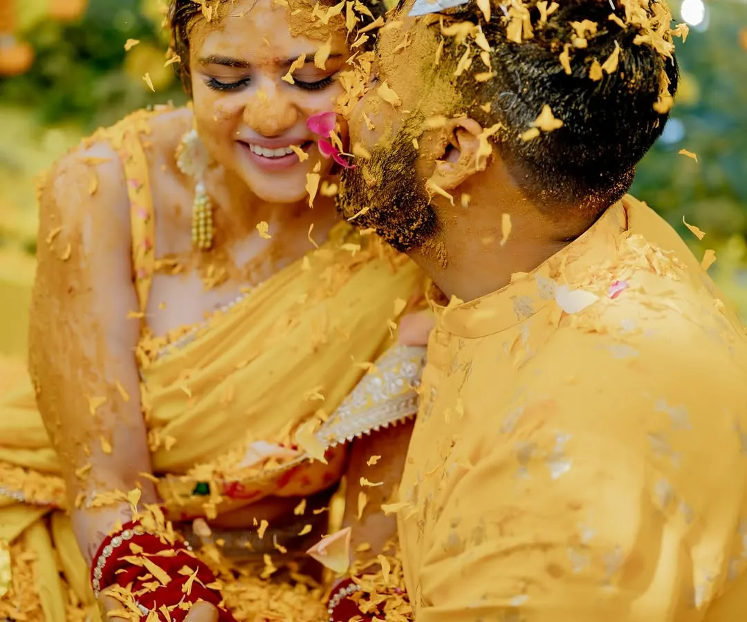 There's a special kind of magic in the chaos of a Haldi ceremony. This candid shot captures a moment of pure, uninhibited joy and affection between the couple, covered in turmeric and love at their destination wedding in Hua Hin, Thailand.