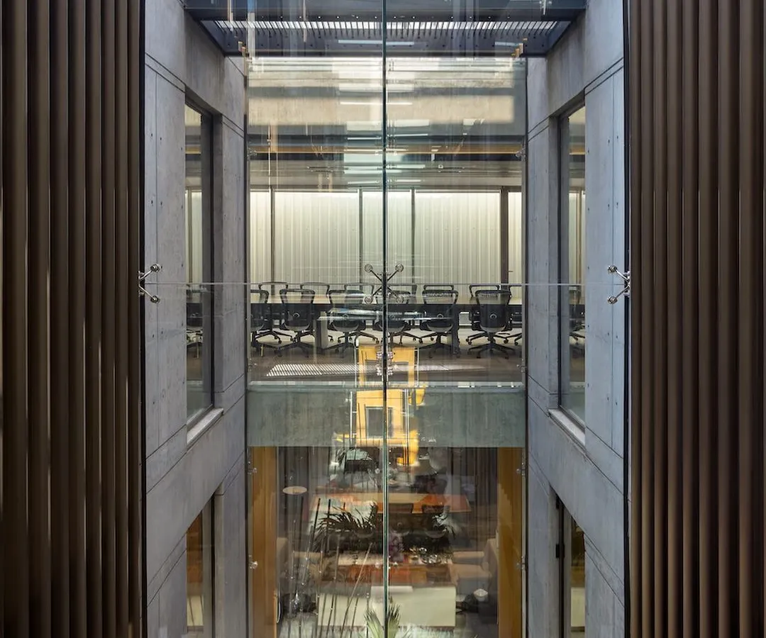 We design interiors as dynamic volumes. At the Laxcon office, we orchestrated a series of triple-height spaces, open-to-sky courtyards, and connecting bridges to foster a sense of openness and visual connection for the workforce, while also responding to the arid climate.