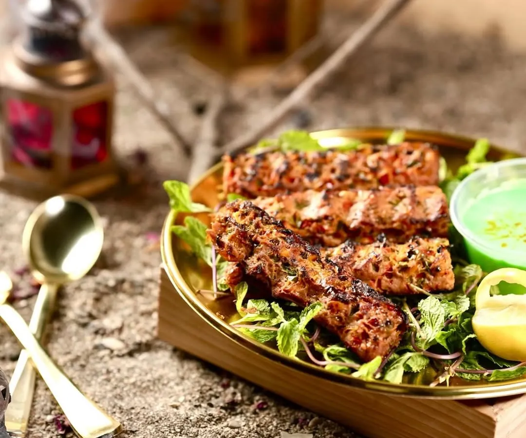 A close-up of my signature Mutton Adana Kebab, grilled to perfection. Each kebab is prepared using authentic techniques, resulting in a smoky flavor and incredibly juicy texture that melts in your mouth.