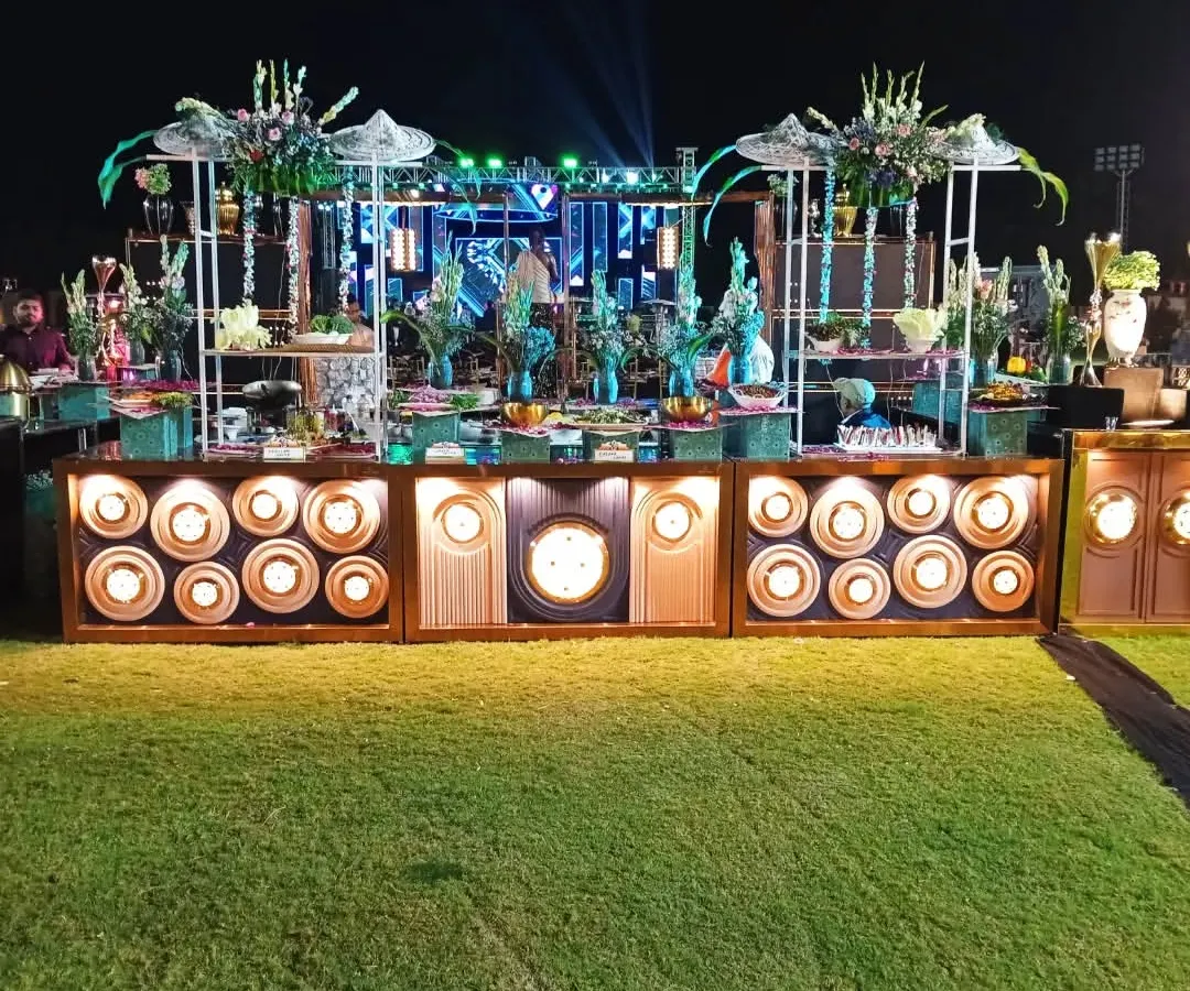 This is an example of my large-scale outdoor catering for a wedding, featuring an elaborate, multi-tiered salad bar that serves as a stunning centerpiece on the lawn.