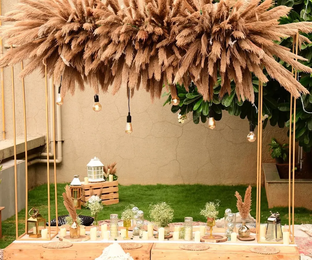 I love designing relaxed, boho-chic sundowners. This rooftop setup features a low sit-down arrangement with plush cushions, a custom pampas grass installation, and warm lighting to create the perfect, dreamy vibe as the sun sets.