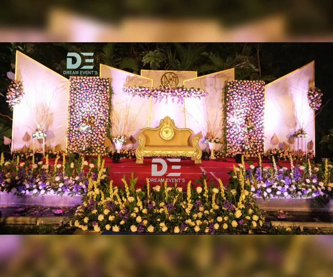 For this grand evening reception in Bengaluru, I created a multi-panel stage with dense floral walls and dramatic uplighting. The elegant gold sofa and intricate flower arrangements provided a luxurious focal point for the couple.