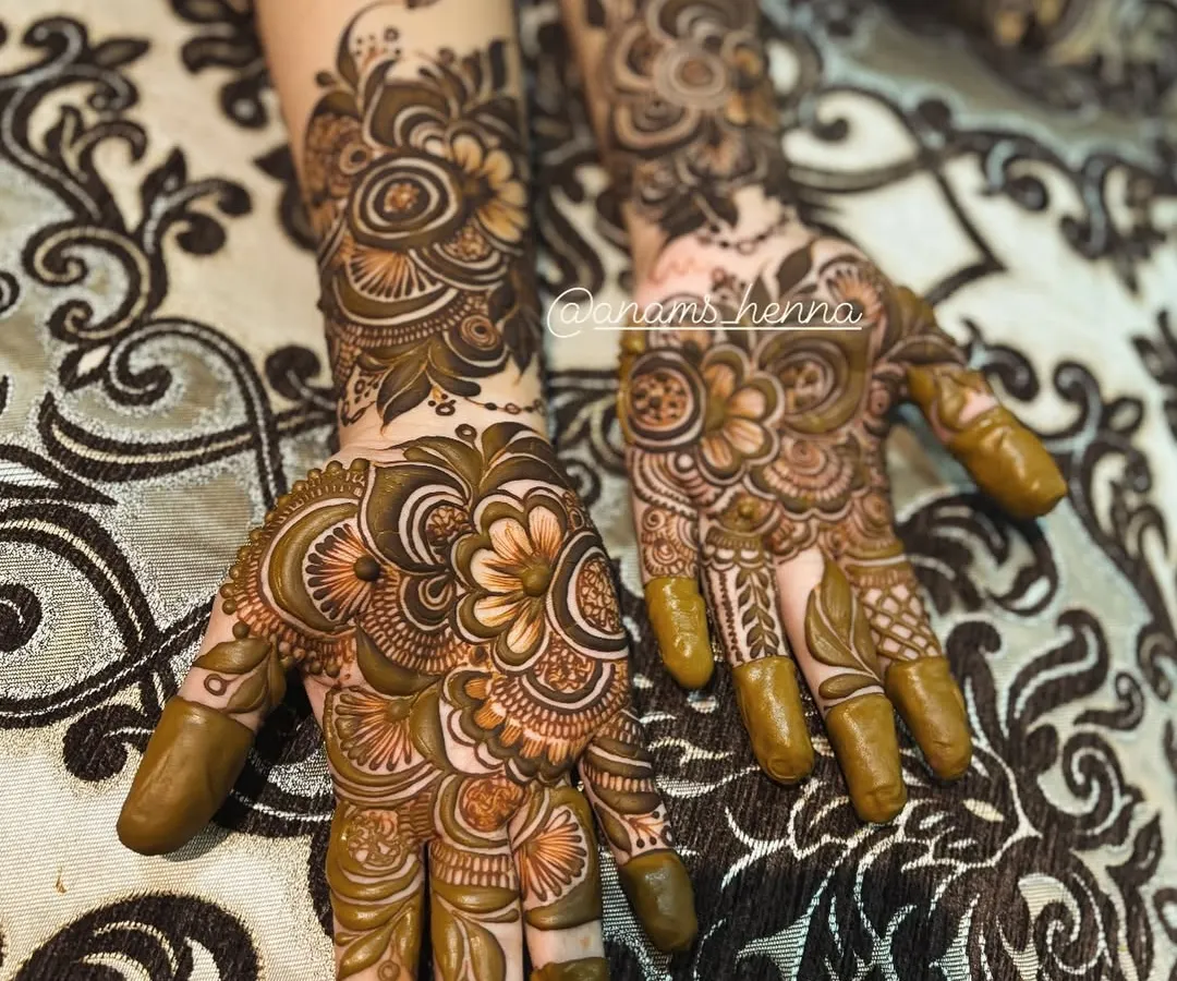 A complete set of intricate henna for both hands, ready for a special occasion. You can see how the patterns on each hand complement each other to create a full, beautiful look.