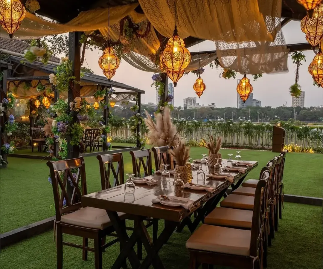 I designed this intimate alfresco dinner setting for a rustic yet romantic feel. The long wooden table, warm Moroccan-style lanterns, and soft fabric draping create a cozy and inviting atmosphere for a special milestone celebration.