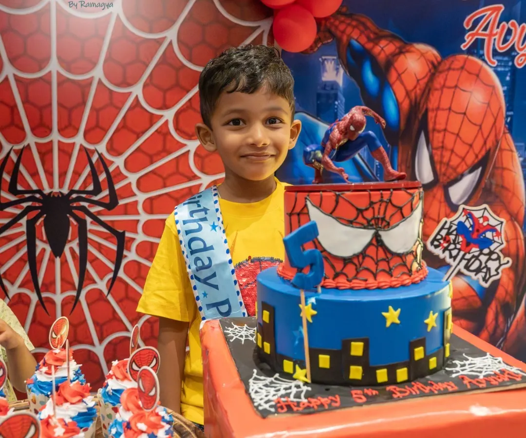 From the cake to the backdrop, I love bringing superhero dreams to life. Here, the birthday boy stands proudly with his amazing Spiderman-themed cake, ready for an action-packed celebration.