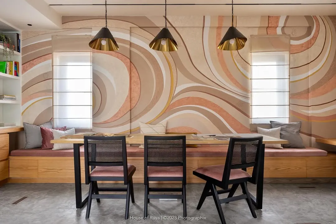 Our studio's conference room balances sophistication and creativity. The custom-painted abstract wall art in earthy pastels creates a soothing atmosphere, while the black-stained Chandigarh chairs provide a sharp, contemporary contrast for focused client meetings.