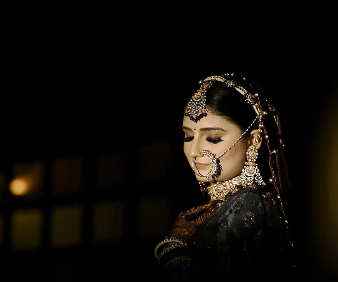 I love using shadows and light to create drama. This bridal portrait focuses on the bride's calm expression and the intricate details of her nath and jewellery, creating a timeless, cinematic feel before the main ceremony.