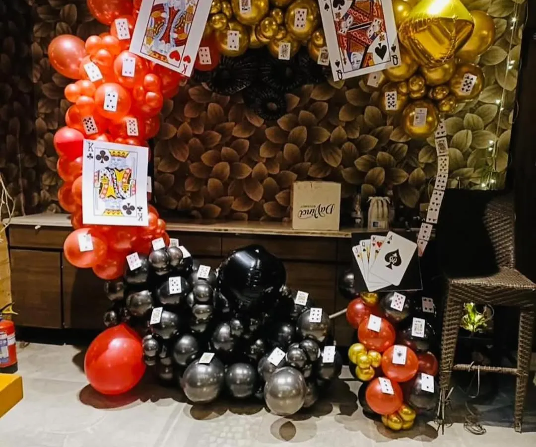 For a fun Diwali card party, I created this unique balloon arch. The design uses red, black, and gold balloons with oversized playing card cutouts. This kind of thematic decor is perfect for creating a memorable party atmosphere.