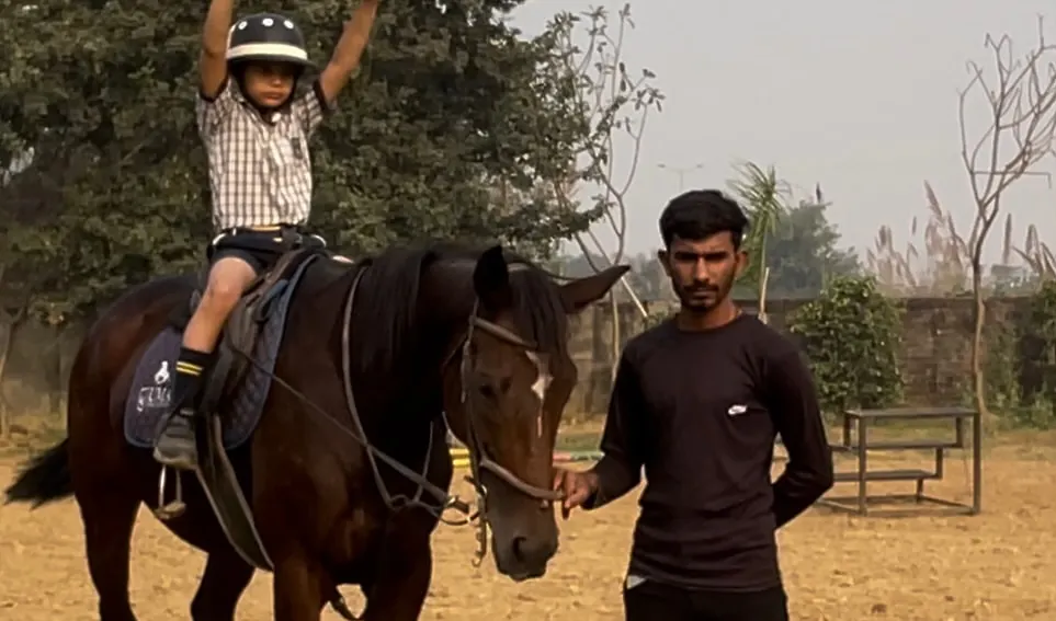 Here, a young rider practices a confidence building exercise under the watchful eye of our instructor. Each session is a safe space for personal growth and achievement.