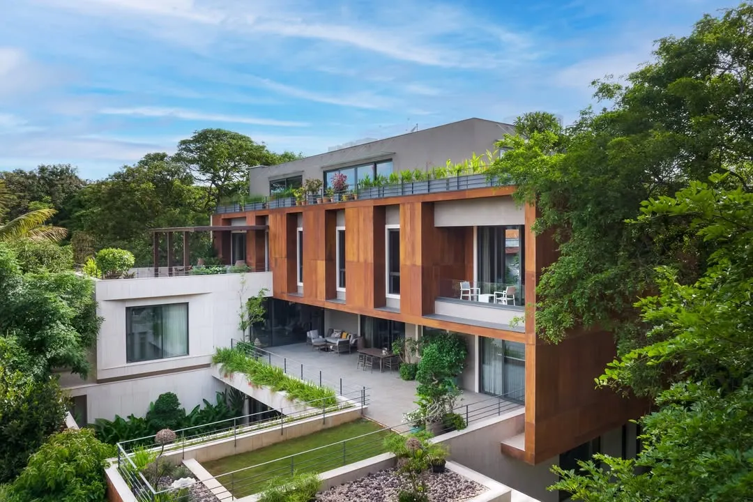 The U-L-I Residence, a 25,000 sq. ft. multigenerational home in Bangalore, is designed to exist in harmony with its lush surroundings. The structure integrates private decks and interconnected courtyards, creating a sanctuary that balances family connection with individual privacy.