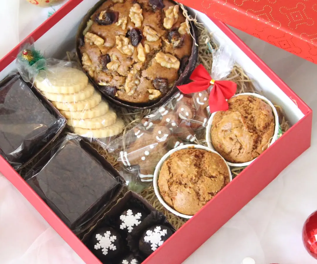 This is my popular Christmas Cheer Box, an assorted hamper perfect for festive gifting. It includes a rich walnut and fruit plum cake, fudgy brownies, classic butter cookies, and gingerbread treats, all packed beautifully for the holiday season.