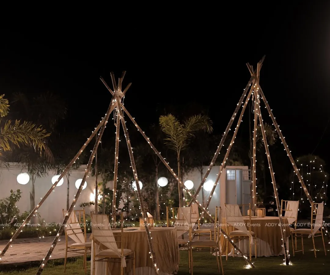 We create magical atmospheres like this "dining under the stars" experience for a milestone birthday. The fairy-lit teepee structures provide an intimate and whimsical setting for guests, perfect for garden parties and boho-themed soirées.