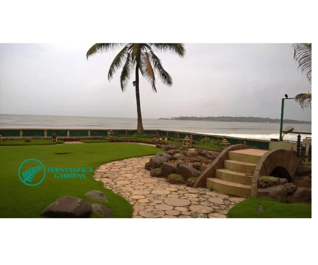 This beautiful seafront villa garden is one of our pride and joy projects. We designed a landscape with a mix of durable lawns, salt-tolerant plants, and hardscaping elements like this stone path and bridge that withstand the coastal climate.