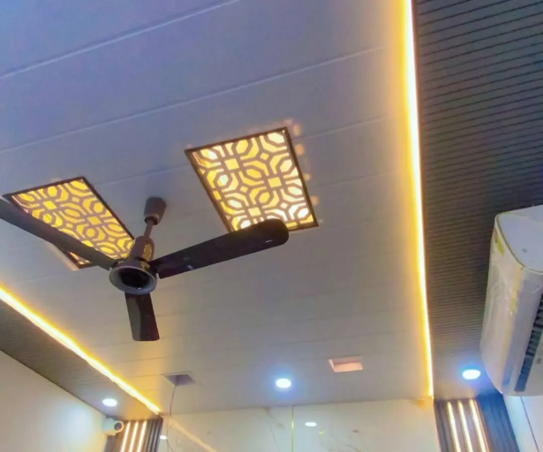 I create modern false ceilings that completely change a room's look. Here you can see a PVC false ceiling with custom geometric cutouts and integrated warm profile lighting, designed to be both stylish and durable. This is a waterproof and termite-proof solution for any home or office.