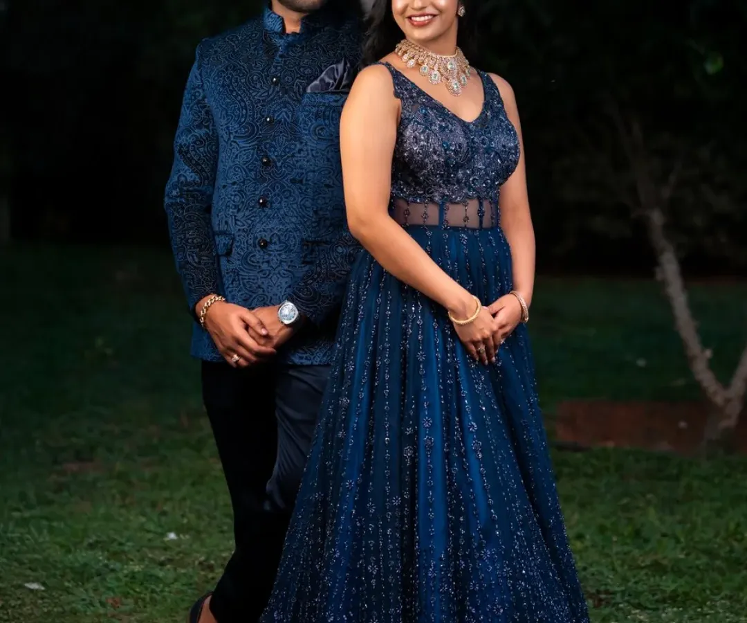 I love creating coordinated outfits for couples. Here, the gentleman wears a custom-embroidered blue bandhgala jacket that complements the sparkling blue katdana corset gown, making them a perfectly matched pair for their special event.