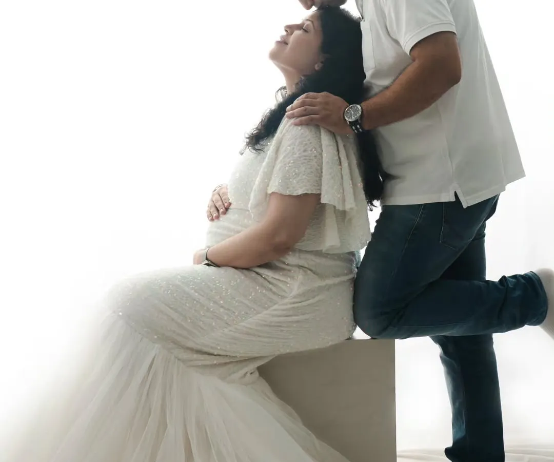 A quiet moment between partners, filled with anticipation. I love creating these soft, high-key portraits that focus purely on the connection and love you share before your little one arrives.