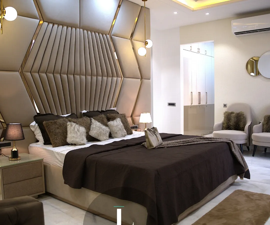 I believe a bedroom should be a personal sanctuary. This master suite features a dramatic, custom-designed geometric headboard in plush, warm tones, creating a focal point that is both luxurious and inviting.