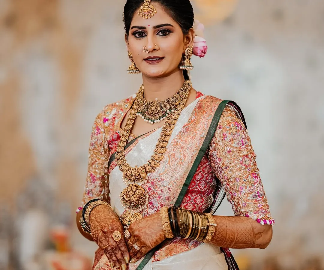 It's a joy to see my clients shine. Here is my beautiful bride Chethana, looking absolutely radiant on her wedding day in her custom-designed Kanchipuram saree and a meticulously hand-embroidered blouse that we created together.