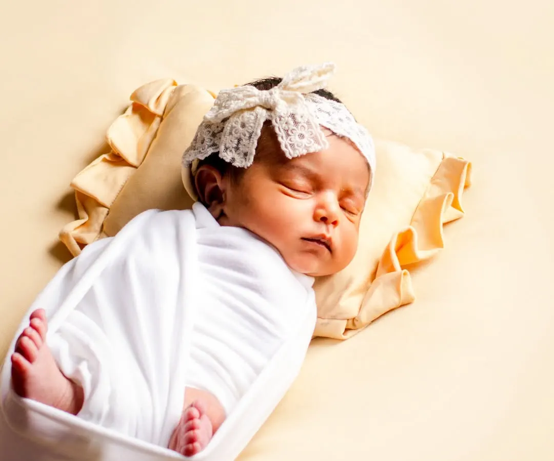 A peaceful, sleeping baby is a beautiful sight. We specialize in safe and comfortable swaddling techniques to keep your newborn snug and content, allowing us to capture these serene moments.