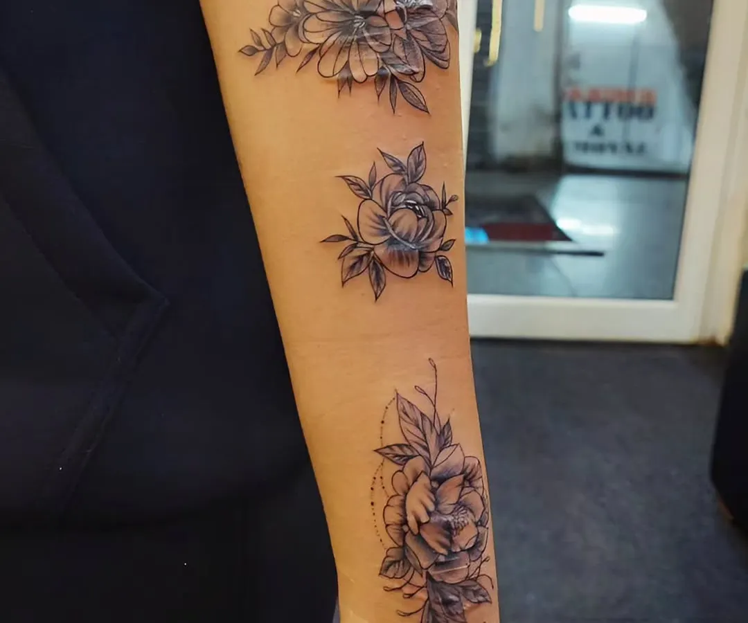 This client wanted to turn a history of self-harm scars into something beautiful. We designed a delicate floral piece that flows along the forearm, using fine-line flowers and soft shading to completely conceal the scars and create a new, positive story.