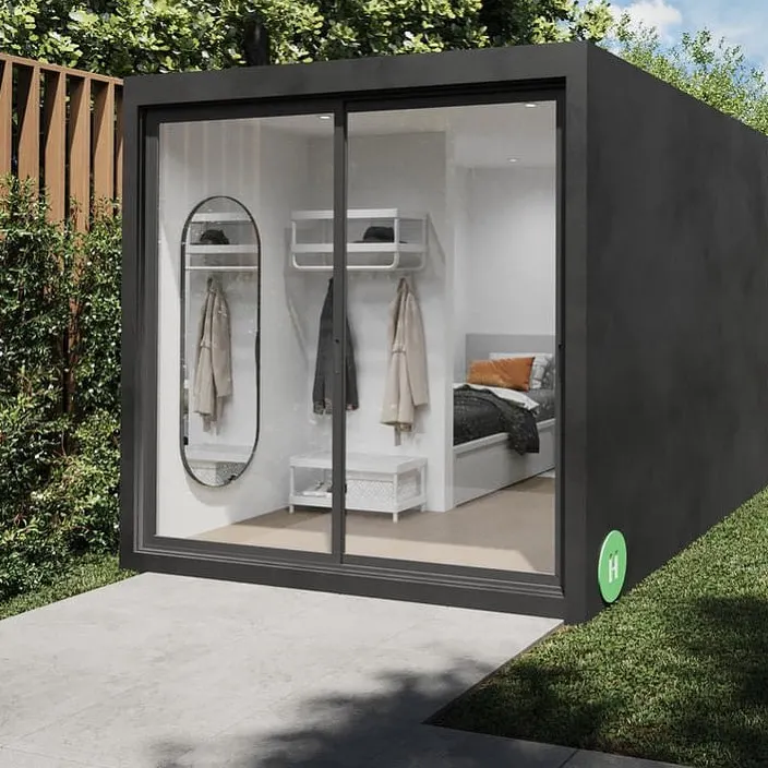 Our signature backyard pod is a versatile solution for adding extra space. This model, shown here with a sleek black frame and sliding glass wall, can be installed in just two months and serves perfectly as a home office, gym, or private studio.
