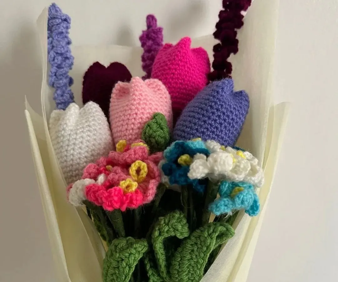 A beautiful handmade bouquet that will never wilt. This arrangement features a mix of colorful tulips, delicate forget-me-nots, and lavender, all crocheted by hand and wrapped beautifully, making it a perfect everlasting gift.