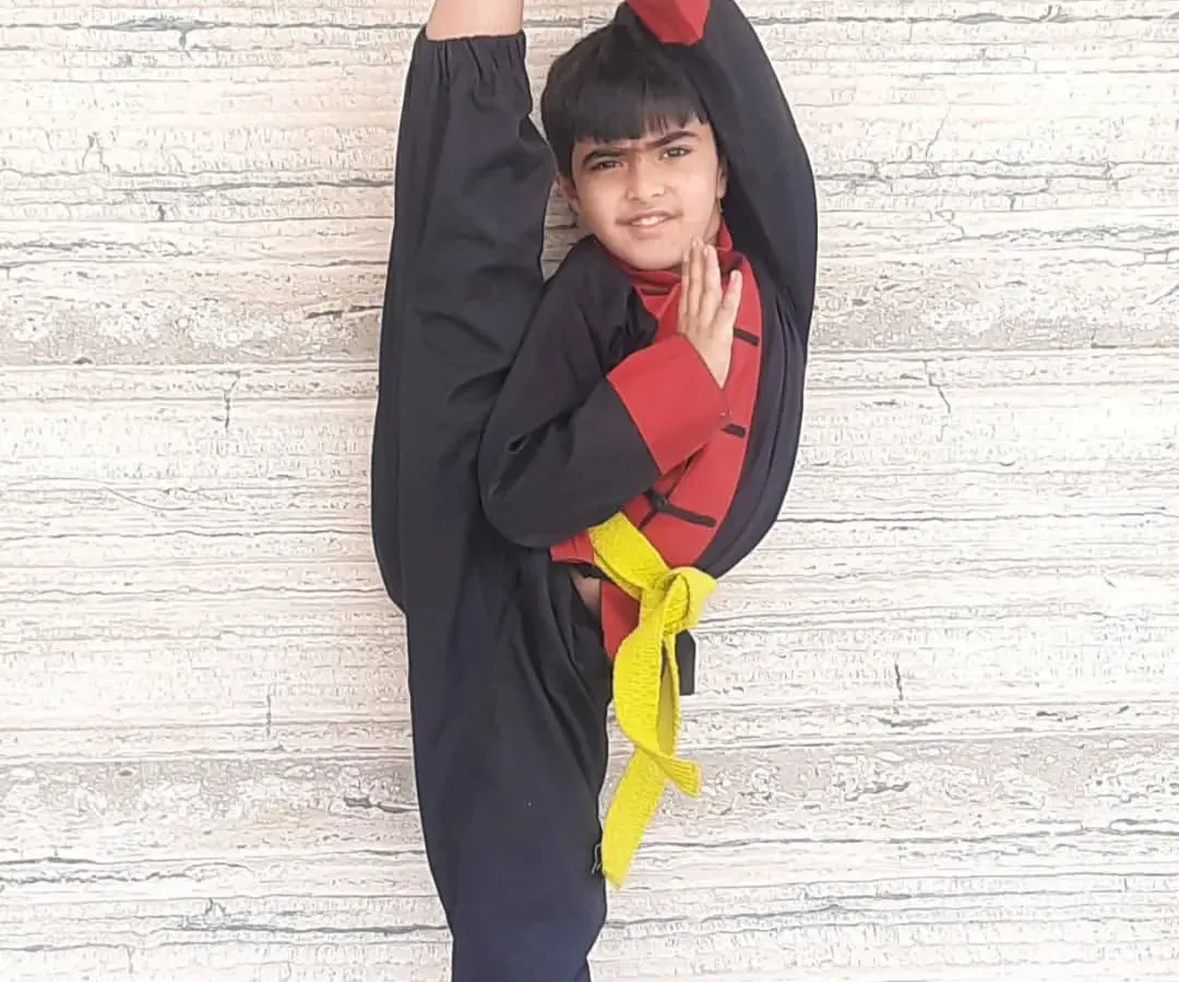 This is what dedication looks like. After one year of consistent training in my Shaolin Kung Fu program, this young student is demonstrating a perfect standing split, showcasing incredible hamstring flexibility and balance.
