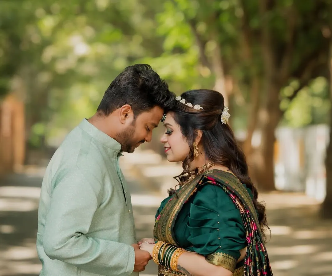 I love capturing the beauty of tradition. This engagement shoot blended Maharashtrian and Bengali cultures, and this quiet moment between the couple, surrounded by greenery, shows the gentle start of their new life together.