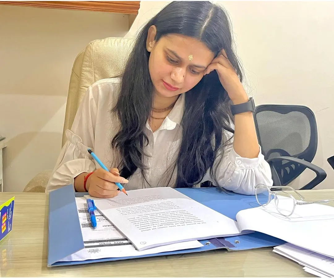 The real work of a lawyer often happens away from the courtroom. Here, I am meticulously reviewing case files and drafting documents, ensuring every detail is perfect before we proceed. My focus is on building a strong, unshakeable case for you.