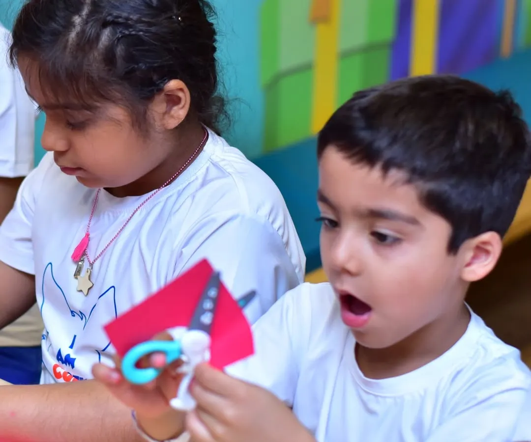 This is the moment of discovery I love to see. In my creative workshops, kids get to explore their curiosity and learn by doing, like this young camper completely absorbed in an arts and crafts project.