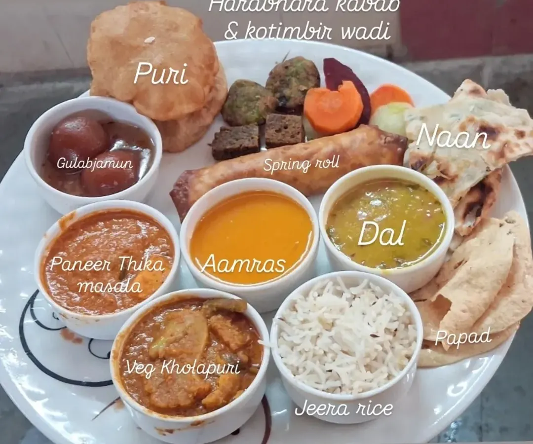 I believe in offering a full, satisfying meal. This plate shows a typical wedding menu I can create, with everything from Paneer Tikka Masala and Veg Kolhapuri to Aamras, Gulabjamun, and fresh Naan.