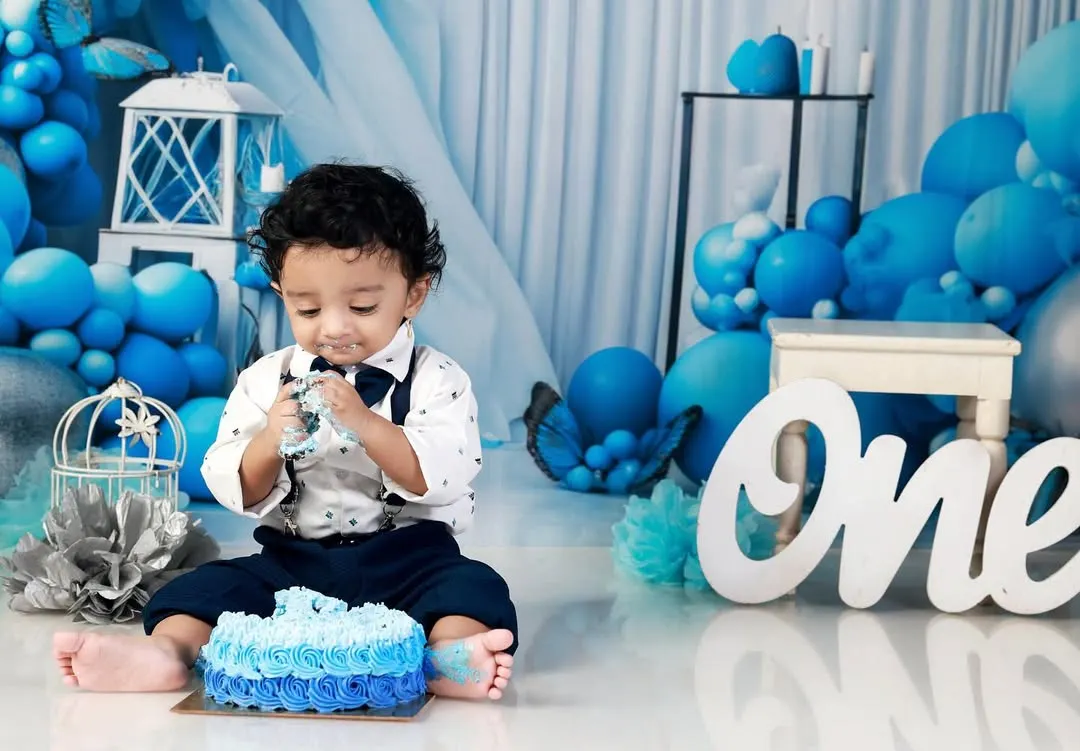 Nothing says "Happy First Birthday" like a cake smash! This little one is having the time of his life with his own cake against our custom blue balloon backdrop. I focus on capturing the messy, candid, and joyful moments of this big milestone.