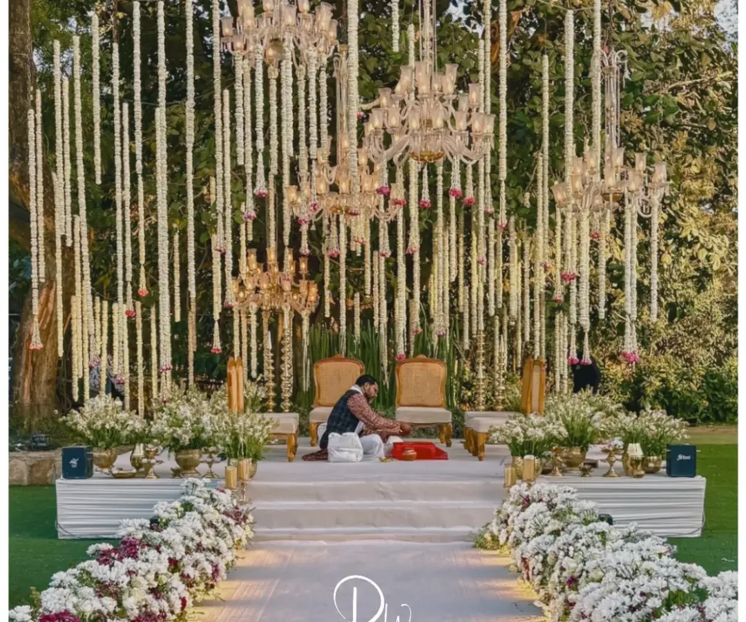 For a touch of timeless Indian opulence, I created this mandap under a canopy of nature. The design features cascading mogra and tuberose, complemented by the warm glow of crystal chandeliers, creating a truly royal and sacred space.