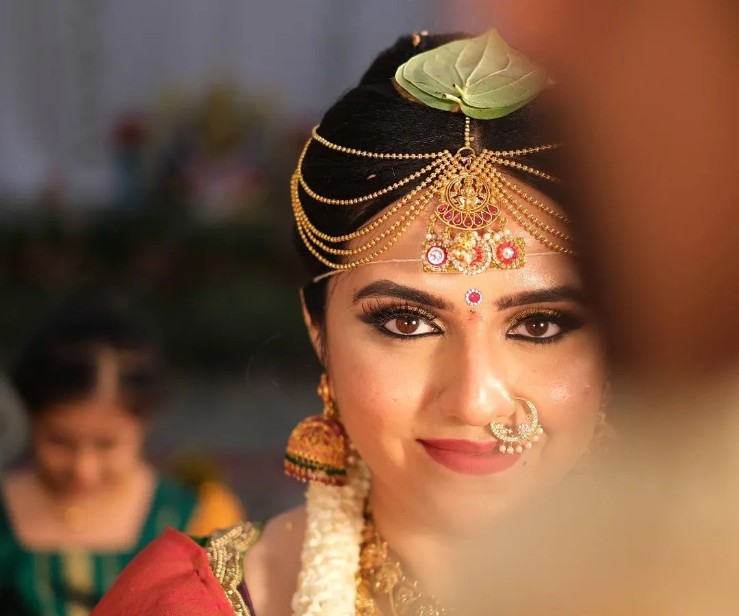 A classic South Indian bridal look, focusing on radiant skin and captivating eyes. This is all about creating that timeless, elegant glow for your big day.