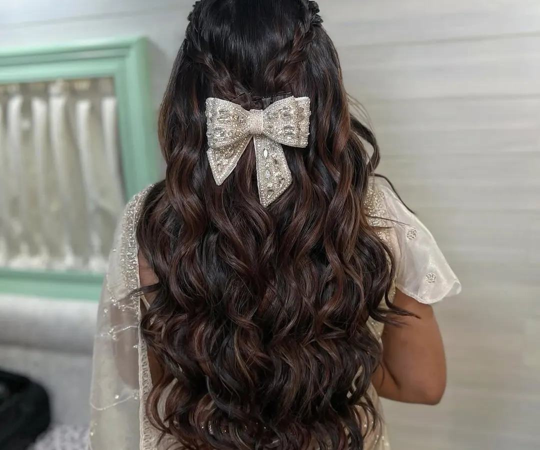 I love how a single accessory can define a look. For this engagement style, I created soft, voluminous waves and added a beautiful oversized bow, embellished with crystals, for a touch of modern fairytale romance.