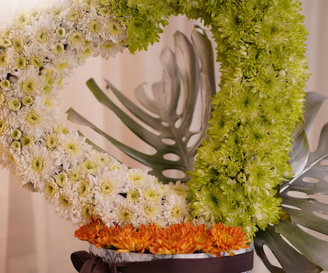 I love creating unique floral sculptures, like this heart-shaped arrangement crafted from green and white chrysanthemums. It's a modern and artistic way to express love or appreciation, presented in a decorative box.