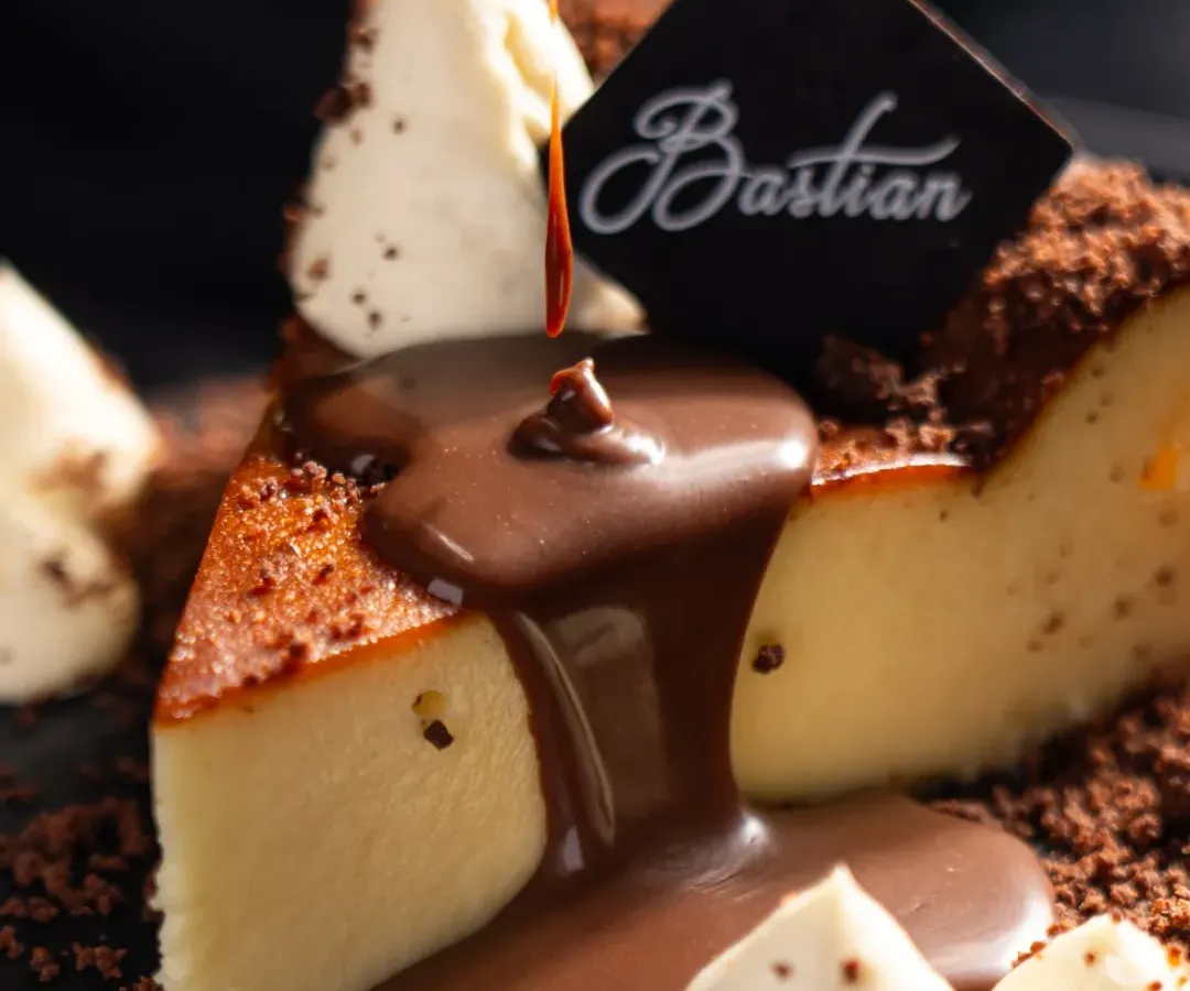 A moment of pure indulgence. For Bastian, we focused on capturing the decadent texture of their famous cheesecake, using a rich chocolate pour to create a dynamic and irresistible dessert photograph.