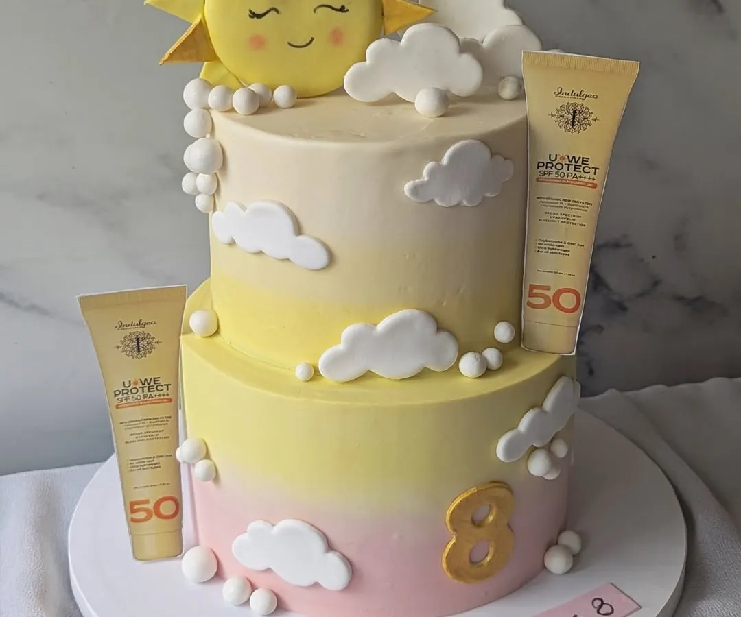 I created this two-tier cake to celebrate the 8th anniversary of Indulgeo Essentials and the launch of their new sunscreen. It features a soft, sky-like buttercream finish and fully edible replicas of the product, turning a brand milestone into a delicious work of art.