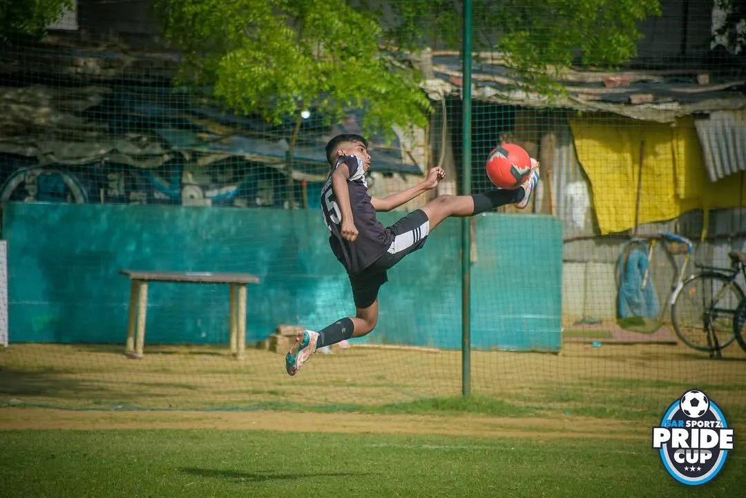 It's all about skill and agility. Here, one of our young athletes executes a perfect aerial kick during a competitive Pride Cup match, showing the high level of technique we teach.
