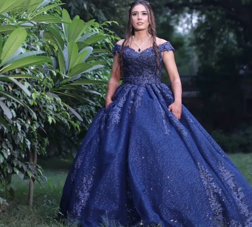 For this client's engagement, we went for a modern fairytale look. The makeup features soft, shimmery eyes and a neutral pink lip to balance her magnificent navy blue ball gown. The goal was to create an elegant and timeless appearance for her outdoor photoshoot.