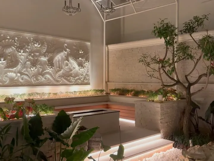 This is an example of a high-end interior courtyard we executed. The project features a stunning bas-relief wall, multi-level planters with integrated seating, and sophisticated lighting to create a serene and luxurious atmosphere, proving that any space can become a work of art.
