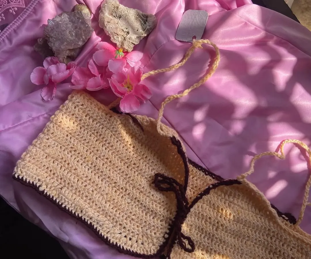 A close-up of one of my handmade halter bikini tops. This one shows a two-tone design with a light cream body and a dark brown border, but you can pick any color combo you want. The straps are fully adjustable for a perfect fit.