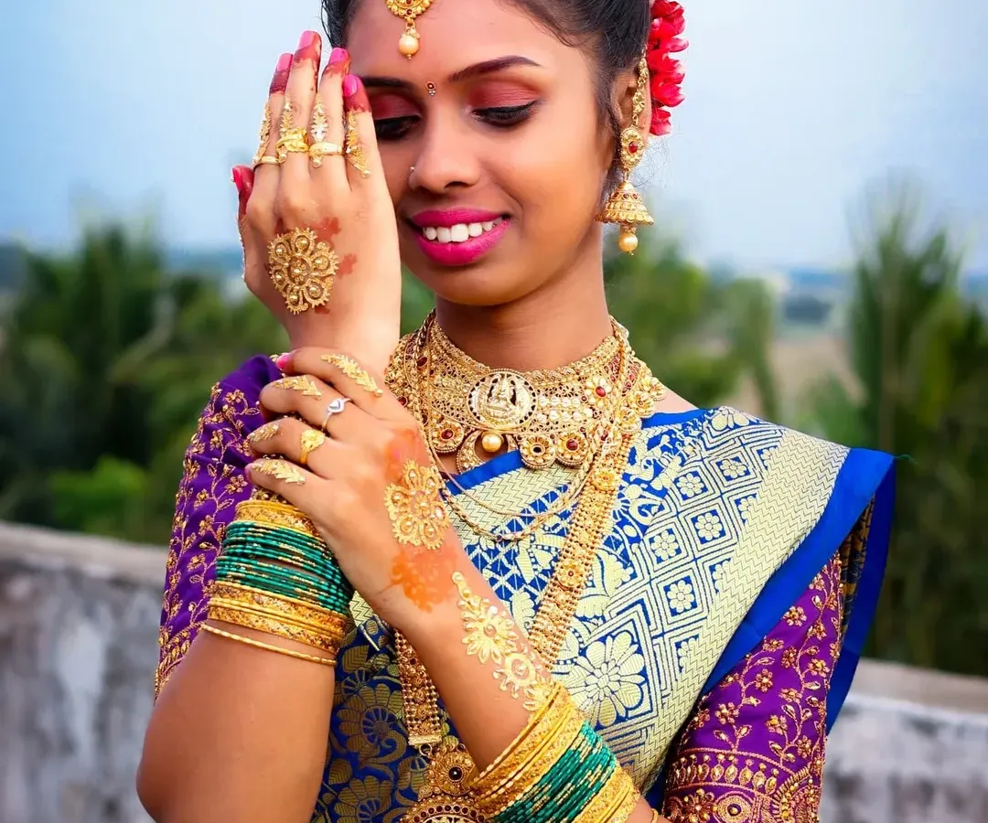 Capturing the grace of a puberty ceremony, or Manjal Neerattu Vizha. This portrait highlights the intricate gold jewelry, the vibrant silk saree, and the beautiful henna details that make this tradition so special.