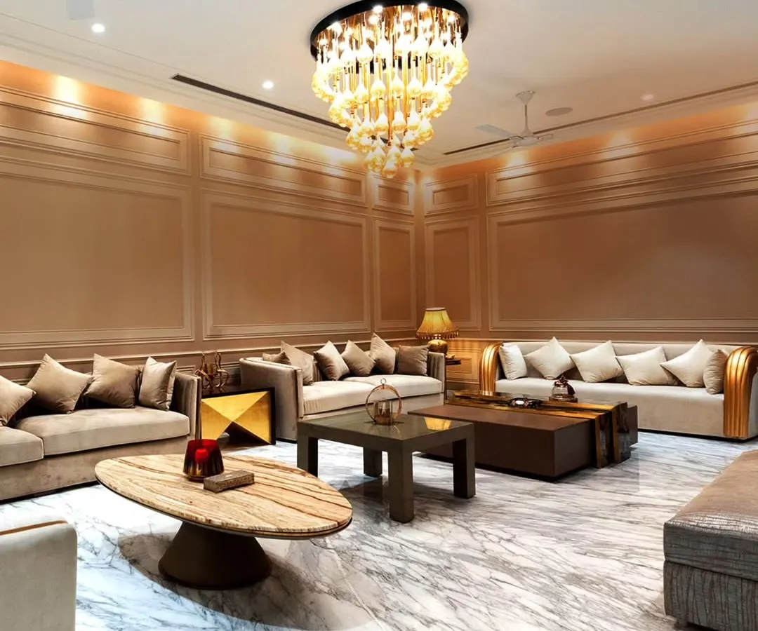 This expansive living room showcases our commitment to opulence and scale. We used Italian marble flooring to create a reflective, bright surface, while the grand chandelier and layered wall paneling add warmth and sophistication.