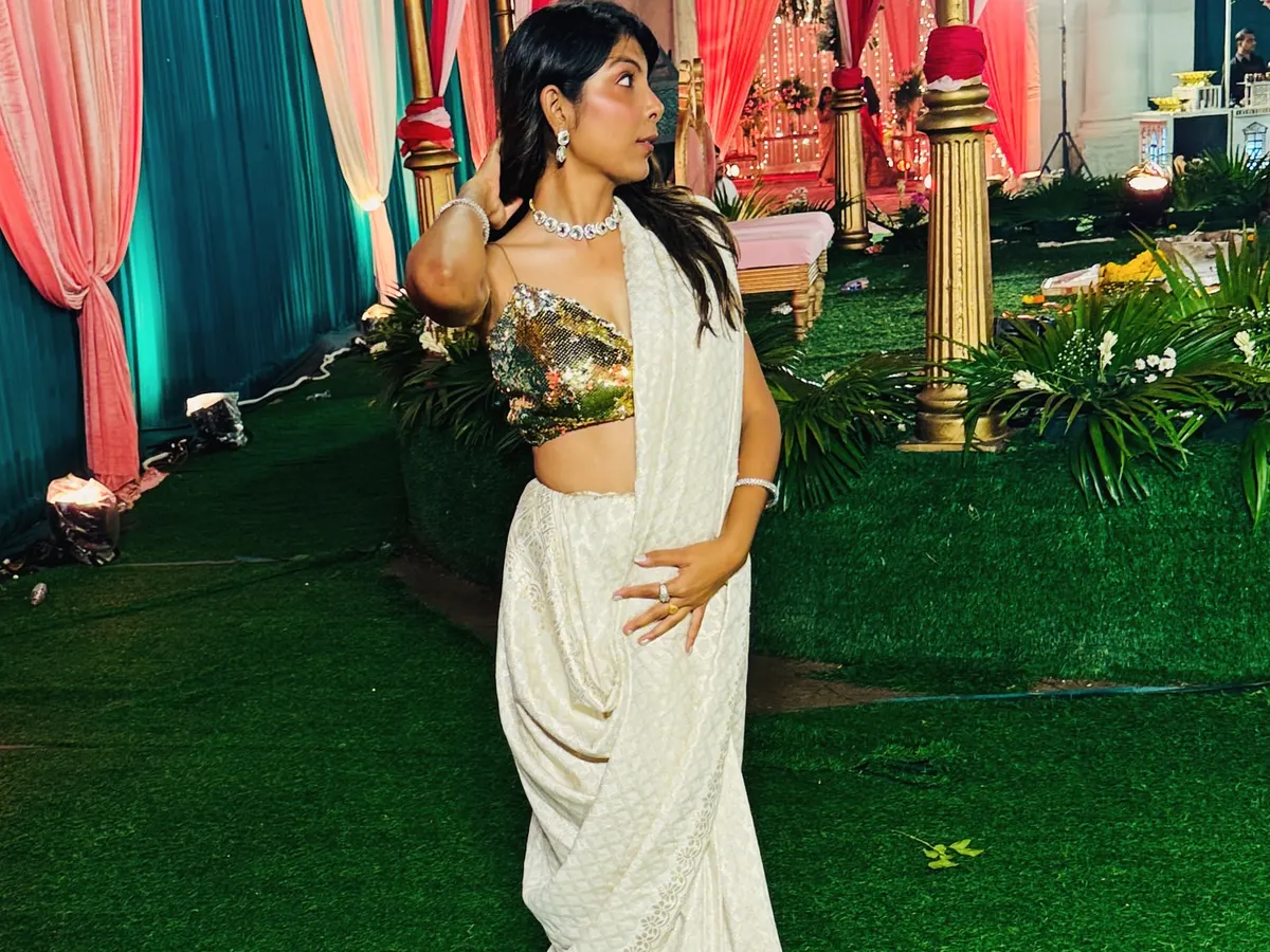 This is one of my favorite looks, a custom-draped saree with a gold sequin blouse that I designed and created from scratch. It's perfect for a cocktail party or a wedding reception. I love helping clients bring their unique vision to life, whether it's for a single event or their entire wedding.