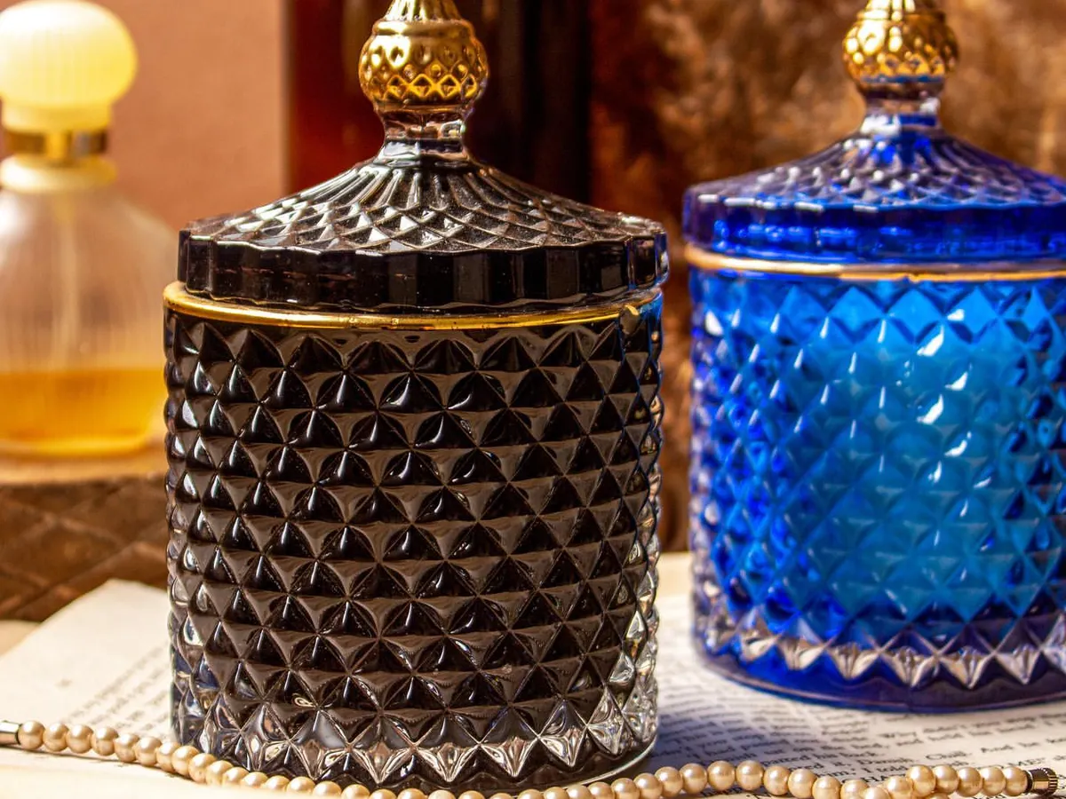 My golden line crystal jar soy candles are designed to add a touch of luxury to your home. This shot shows the elegant black and royal blue jars, which can be filled with any custom fragrance you choose, from cozy Oud to fresh Lily Rose.