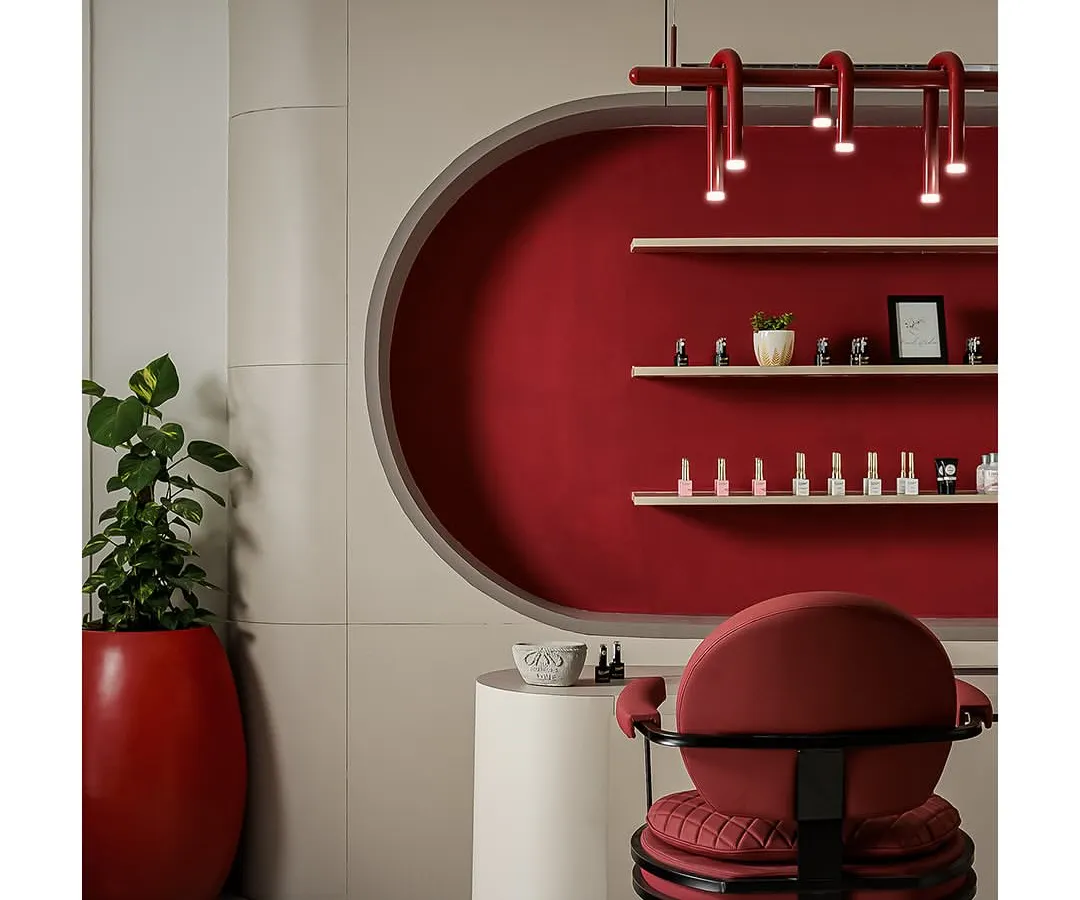 For this chic commercial space, I combined bold color with sophisticated textures. This nail station at Snob Salon features a striking crimson alcove, custom lighting, and plush seating, creating an indulgent and memorable client experience.
