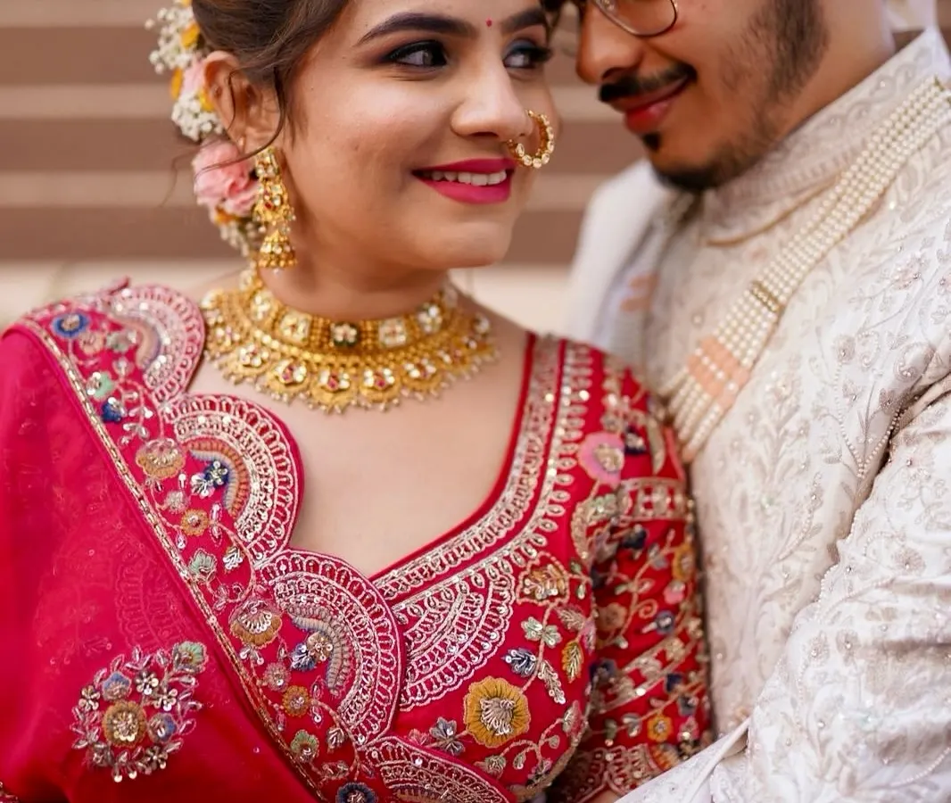A close-up of a classic red bridal look. The focus is on creating luminous skin, beautifully defined eyes, and a bold lip that complements the traditional attire, ensuring the bride feels radiant and confident. ❤️