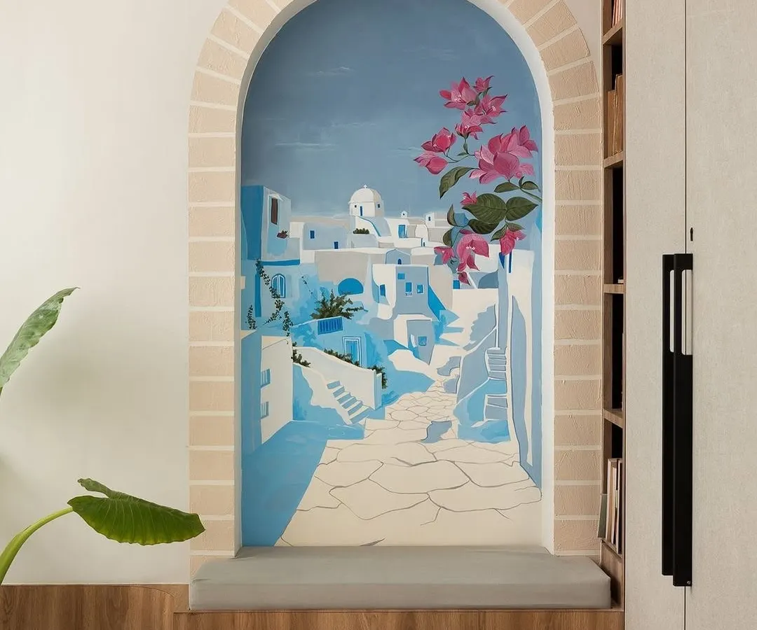 A small nook in a master bedroom becomes a window to Santorini. This scenic mural is designed to transport you, creating a personal seaside retreat and a serene escape within your own home.